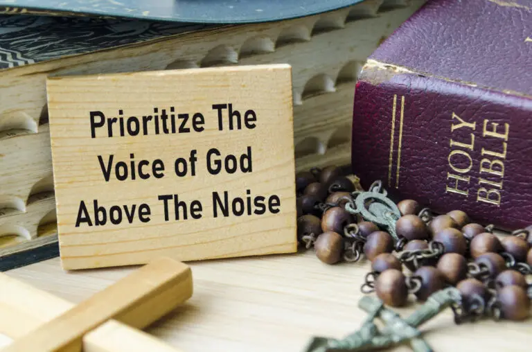 picture of Bible on desktop with plaque "Prioritize the Voice of God Above the Noise"